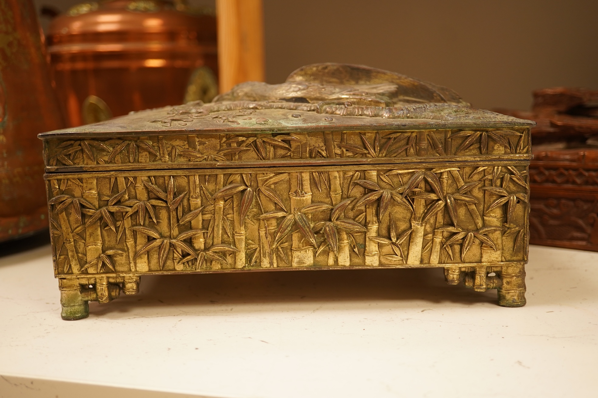 A late 19th century Japanese gilt metal lidded box together with a Burmese carved hardwood box, 28cm wide